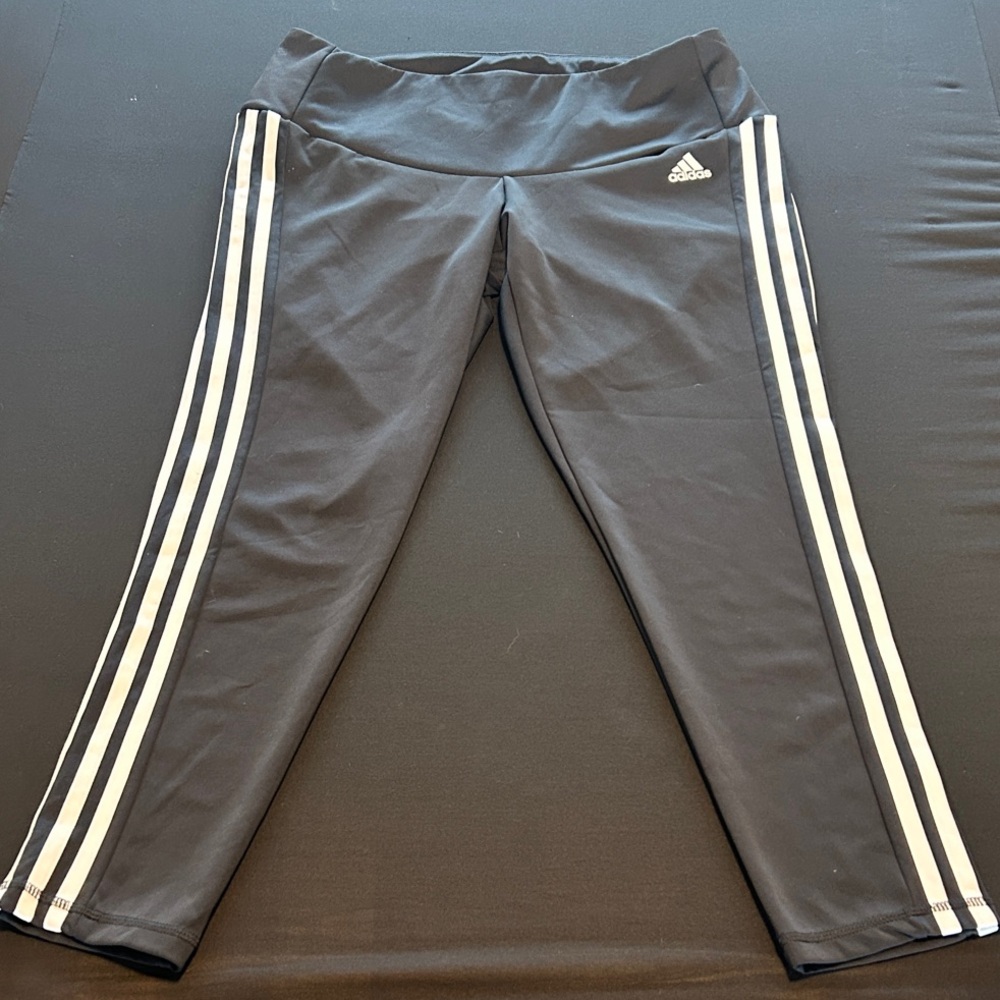 Adidas Women’s 1X athletic leggings with classic white side stripes.